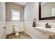 Well-lit half bathroom featuring wainscoting and modern fixtures at 7306 Timbercreek Ct, Denver, NC 28037