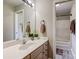 Bathroom featuring a sleek vanity, ample lighting, and a mirrored wall at 7306 Timbercreek Ct, Denver, NC 28037