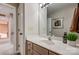 Bathroom featuring a vanity with cream countertops, mirror, decorative plants, and neutral paint at 7306 Timbercreek Ct, Denver, NC 28037