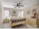 Bedroom showcasing neutral walls, with art, two windows and a decorative ceiling fan above a decorative bed at 7306 Timbercreek Ct, Denver, NC 28037