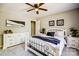 Bedroom featuring light neutral walls, ceiling fan, white furniture, and natural lighting at 7306 Timbercreek Ct, Denver, NC 28037