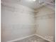Walk-in closet with white shelving and neutral-colored walls at 7306 Timbercreek Ct, Denver, NC 28037