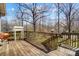 Wooden deck and railing with a grill, plus a staircase leading to the yard and house beyond at 7306 Timbercreek Ct, Denver, NC 28037