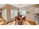 Sunlit dining area features hardwood floors and a view of the outdoors at 7306 Timbercreek Ct, Denver, NC 28037
