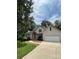 Exterior daytime view of a home featuring a lawn, trees, brick and siding at 7306 Timbercreek Ct, Denver, NC 28037