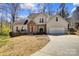 Charming home with stone accents, a two-car garage, and a well-manicured front yard at 7306 Timbercreek Ct, Denver, NC 28037