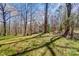 Secluded home featuring mature trees, a lush green lawn, and peaceful surroundings at 7306 Timbercreek Ct, Denver, NC 28037