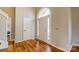 Bright foyer showcasing hardwood floors and a large arched window above the front door at 7306 Timbercreek Ct, Denver, NC 28037
