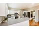 Bright kitchen features white cabinetry, stainless steel appliances, and hardwood floors at 7306 Timbercreek Ct, Denver, NC 28037