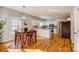 Eat-in kitchen features white cabinets, modern appliances, and hardwood floors for a warm feel at 7306 Timbercreek Ct, Denver, NC 28037