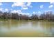 Picturesque lake view showcasing the serene water, homes, and lush greenery at 7306 Timbercreek Ct, Denver, NC 28037