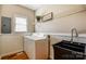 Well-lit laundry room with updated sink, countertops, shelving and a washer and dryer at 7306 Timbercreek Ct, Denver, NC 28037
