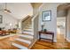 View of open living space with hardwood floors, staircase, table and a glimpse of the kitchen at 7306 Timbercreek Ct, Denver, NC 28037