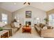 Comfortable living room with a fireplace, neutral tones, and ample natural lighting at 7306 Timbercreek Ct, Denver, NC 28037