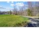 Manicured green space featuring a scenic path and lovely tree line at 7306 Timbercreek Ct, Denver, NC 28037