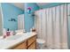 A full bathroom showing a granite countertop, a sink, and a toilet at 8808 Shady Pine Ct, Charlotte, NC 28214