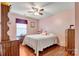 A pink bedroom with a bright window and wood floors at 8808 Shady Pine Ct, Charlotte, NC 28214