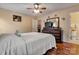 A cozy bedroom featuring hardwood floors and a comfy bed with a matching dresser and mirror at 8808 Shady Pine Ct, Charlotte, NC 28214