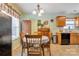 Charming dining area featuring tile floors and a dining table with seating, adjacent to the kitchen at 8808 Shady Pine Ct, Charlotte, NC 28214