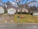 Charming single-story home with a well-manicured lawn, inviting curb appeal, and an attached one-car garage at 8808 Shady Pine Ct, Charlotte, NC 28214