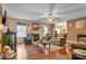 Comfortable living room featuring a fireplace, hardwood floors, and abundant natural light from the large windows at 8808 Shady Pine Ct, Charlotte, NC 28214