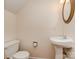 Cozy half bathroom with a pedestal sink and classic toilet at 9128 Kings Canyon Dr, Charlotte, NC 28210