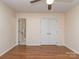 This is a bedroom with light walls, wood-look flooring and a closet with double doors at 9128 Kings Canyon Dr, Charlotte, NC 28210