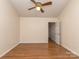 Bedroom with ceiling fan and hardwood flooring, illuminated by natural light at 9128 Kings Canyon Dr, Charlotte, NC 28210