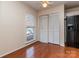Bedroom with hardwood floors, closet, and natural light from a bright window at 9128 Kings Canyon Dr, Charlotte, NC 28210