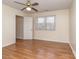 Bedroom featuring light walls, wood-look flooring, ceiling fan and a window providing natural light at 9128 Kings Canyon Dr, Charlotte, NC 28210