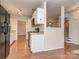 Open kitchen with stainless steel refrigerator, hardwood floors, and views of the staircase at 9128 Kings Canyon Dr, Charlotte, NC 28210