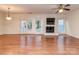 Open living room featuring hardwood floors, fireplace and doors to the outside at 9128 Kings Canyon Dr, Charlotte, NC 28210