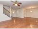 Open concept floor plan with hardwood floors, stairs and ceiling fan at 9128 Kings Canyon Dr, Charlotte, NC 28210