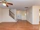 Spacious living room with wood floors and stairs to the second level at 9128 Kings Canyon Dr, Charlotte, NC 28210