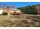 Spacious backyard features a wooden deck, a brick chimney, and plenty of room for outdoor activities at 105 Brickyard Rd, Fort Mill, SC 29715