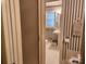 Cozy bathroom with classic blue striped wallpaper, pedestal sink, and white tile flooring at 105 Brickyard Rd, Fort Mill, SC 29715