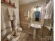 Bathroom featuring a pedestal sink, tiled floors, a decorative mirror and vanity cabinet at 105 Brickyard Rd, Fort Mill, SC 29715
