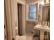 Bathroom featuring striped wallpaper, pedestal sink, medicine cabinet, and white fixtures at 105 Brickyard Rd, Fort Mill, SC 29715