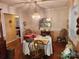 Charming dining room featuring hardwood floors, a classic chandelier, and plenty of natural light at 105 Brickyard Rd, Fort Mill, SC 29715
