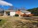View of the exterior of the home showing a backyard deck, a covered carport, and a brick chimney at 105 Brickyard Rd, Fort Mill, SC 29715