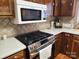 Updated kitchen featuring a stainless steel gas range, a white microwave, and tile backsplash at 105 Brickyard Rd, Fort Mill, SC 29715