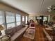 Bright living room with hardwood floors, ample windows, and comfortable seating, great for relaxing and entertaining at 105 Brickyard Rd, Fort Mill, SC 29715