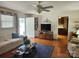 Cozy living room with hardwood floors, a white brick wall and neutral furniture at 105 Brickyard Rd, Fort Mill, SC 29715