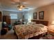Comfortable main bedroom with floral bedding, ceiling fan, and natural light from the windows at 105 Brickyard Rd, Fort Mill, SC 29715