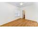 Light-filled bedroom with wood floors, a ceiling fan, and a window providing ample natural light at 10530 Stoneacre Ct, Pineville, NC 28134