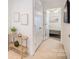 Inviting hallway featuring white walls, carpet, decorative art, and a glimpse into a bright bedroom at 10530 Stoneacre Ct, Pineville, NC 28134