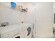 Functional laundry room with washer, dryer, shelving and ample storage space at 10530 Stoneacre Ct, Pineville, NC 28134