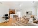 Open-concept living area featuring a comfortable sofa, dining space, and kitchen in a naturally lit interior at 10530 Stoneacre Ct, Pineville, NC 28134