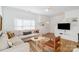 Bright living room with a cozy sectional sofa, wood floors, and modern decor creating a welcoming atmosphere at 10530 Stoneacre Ct, Pineville, NC 28134