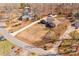 Aerial view of the brick home and surrounding landscape, showcasing its setting within a neighborhood at 11 Heritage Ln, Shelby, NC 28150